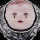 Broche tête de poupée