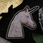Broche licorne "eat the rich"