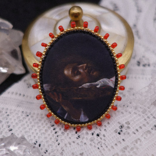 Broche tête coupée