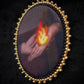 Broche mains et flamme