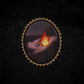 Broche mains et flamme
