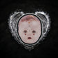 Broche tête de poupée