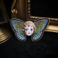 Broche poupée papillon
