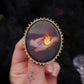 Broche mains et flamme